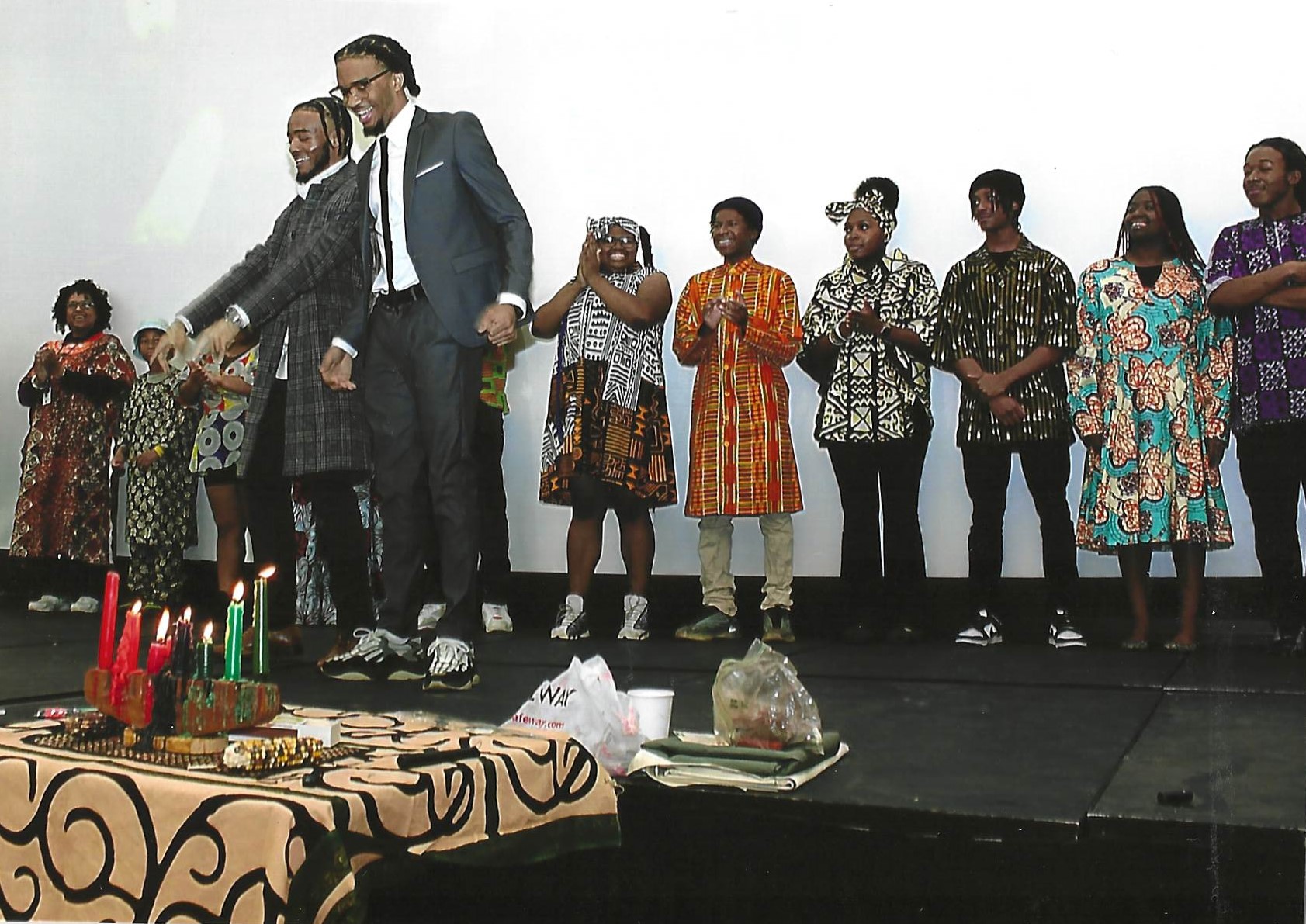 Students speaking with fashion show lined up behind