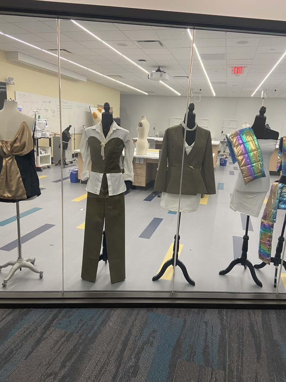 Fashion Sewing Lab display window showing garments by students