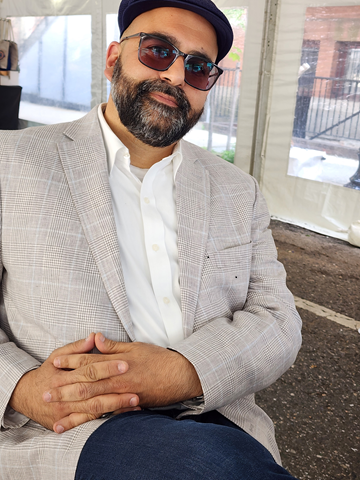 Photo of Dr. Zahedi, wearing sunglasses, jacket and a hat. 
