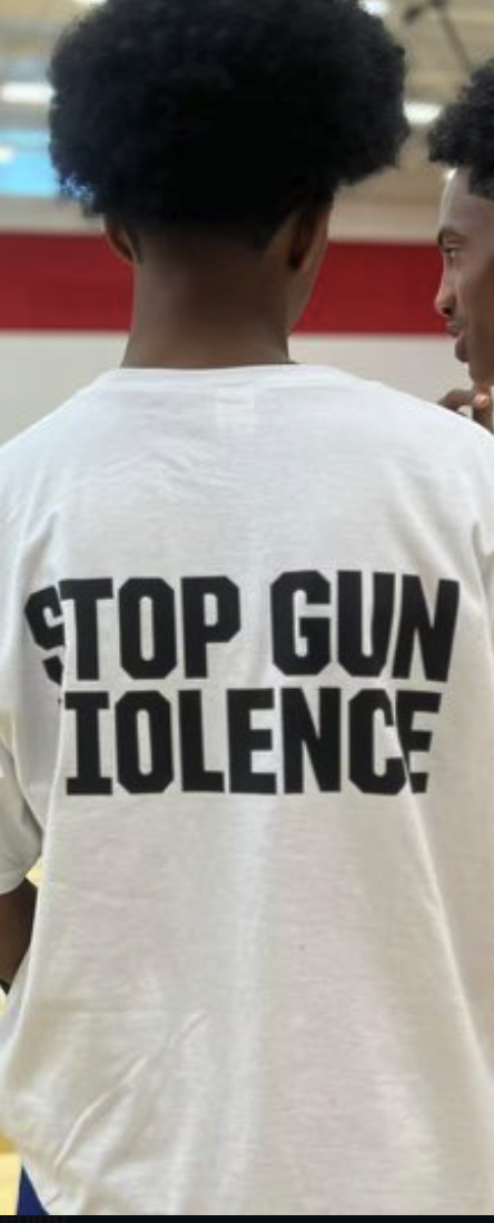 Young black boy with stop gun violence tee shirt, back to camera
