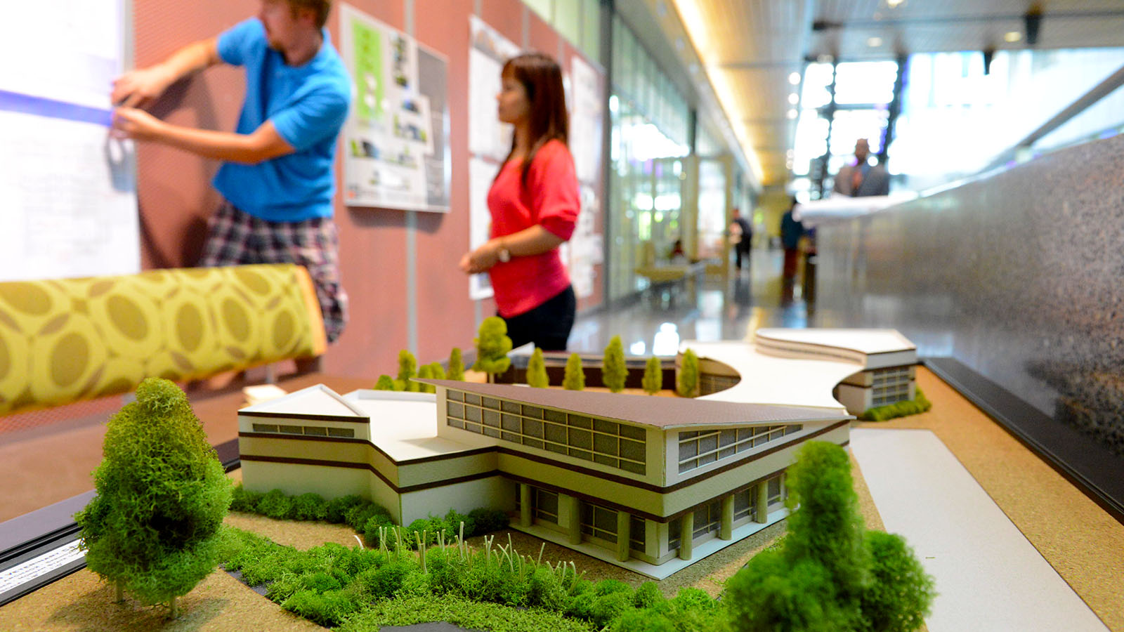 two architecture students with building model