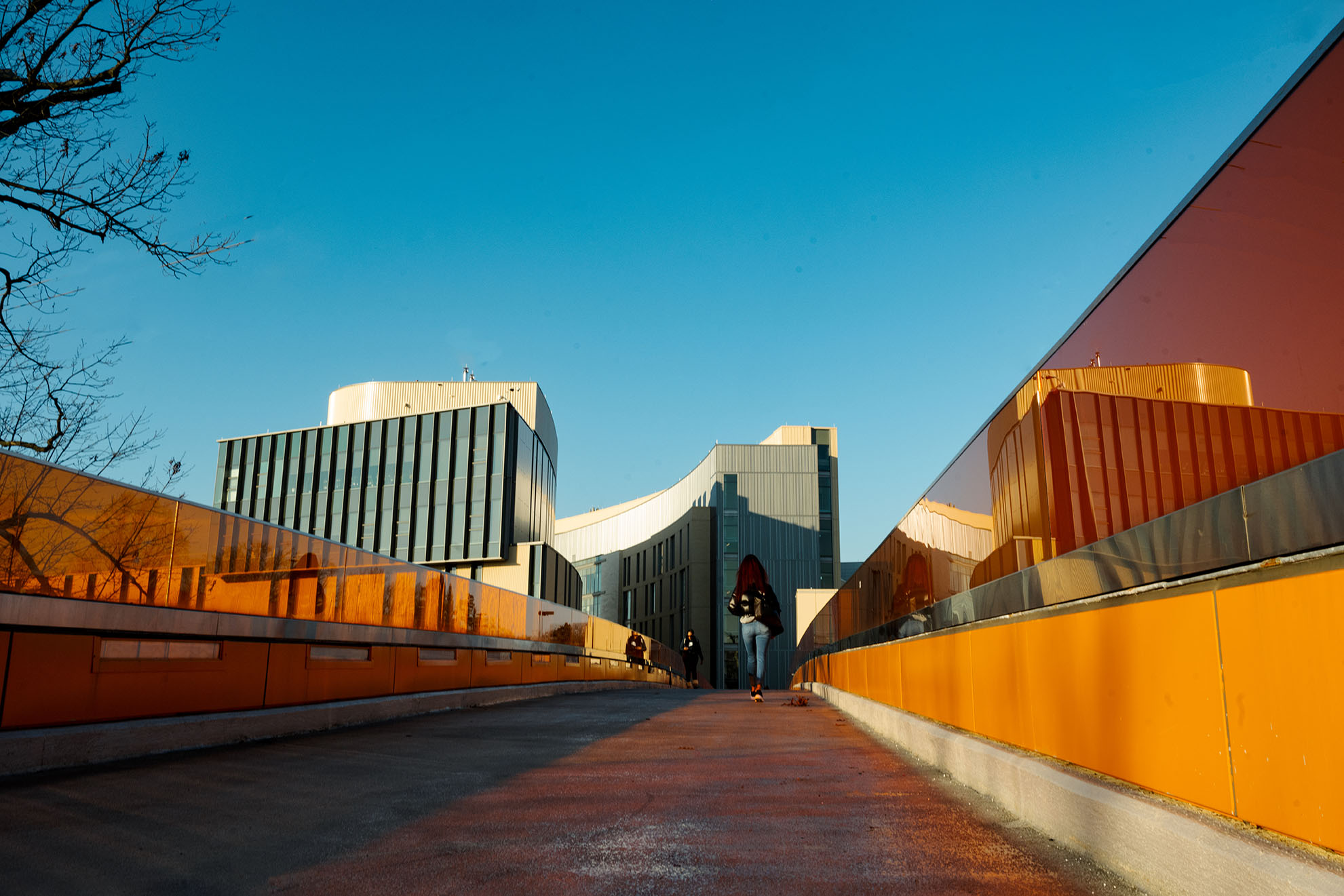 student walking on bridge