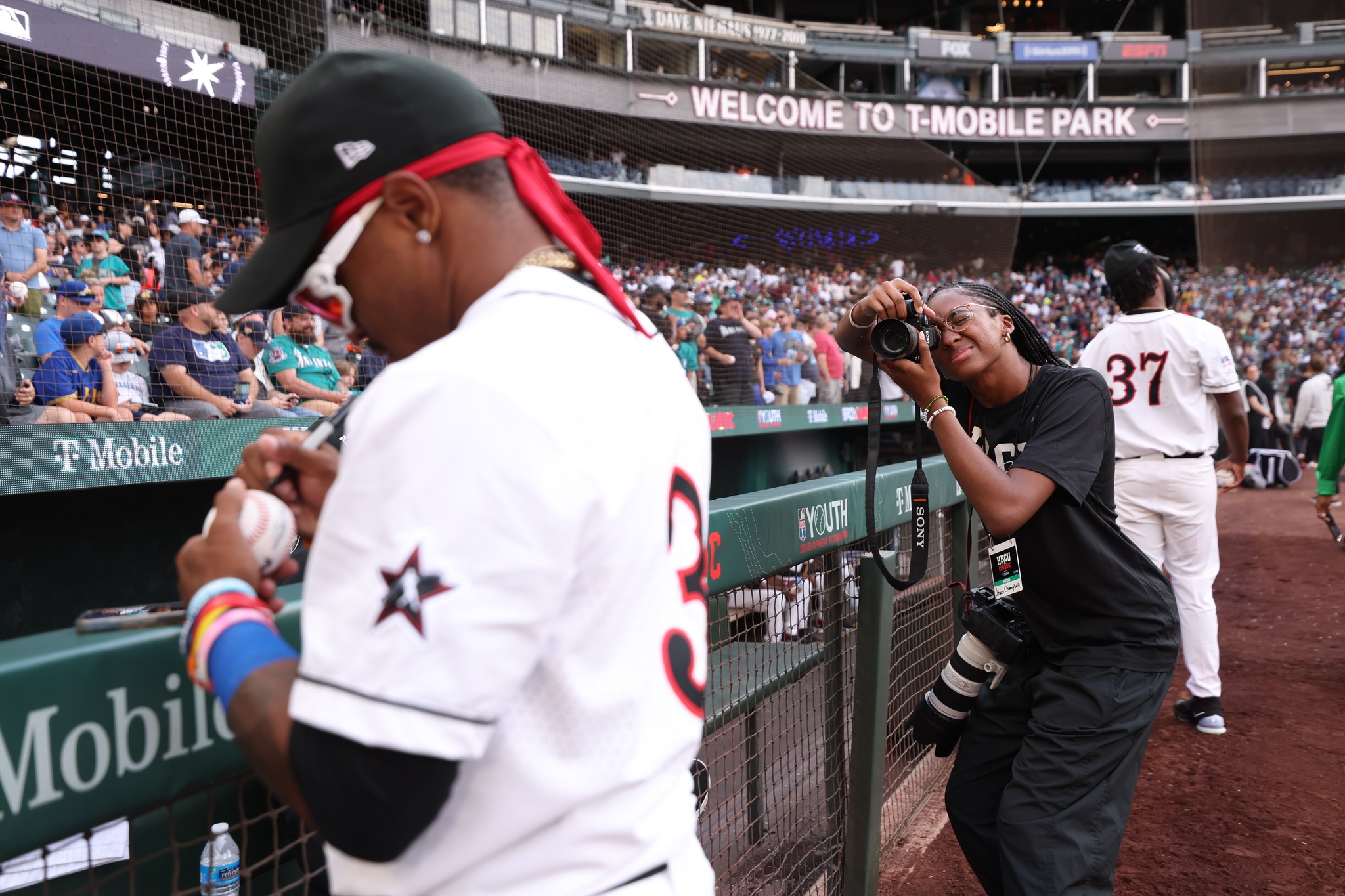 student photographer photographing all-star baseball player