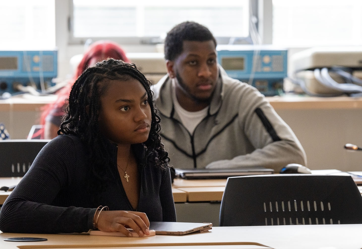female and male student paying attention in class