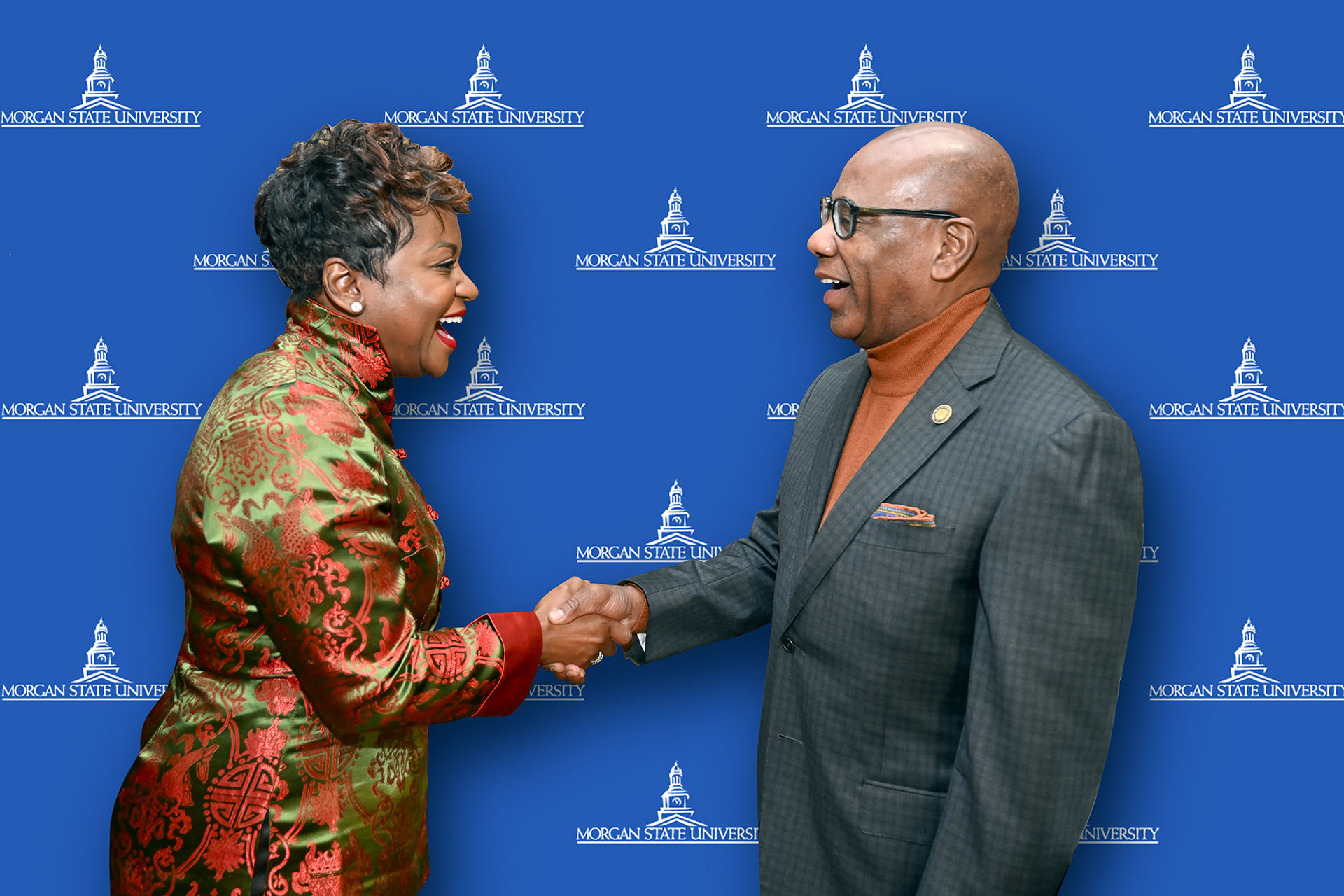 Endia DeCordova and President David Wilson sharing a joy-filled handshake