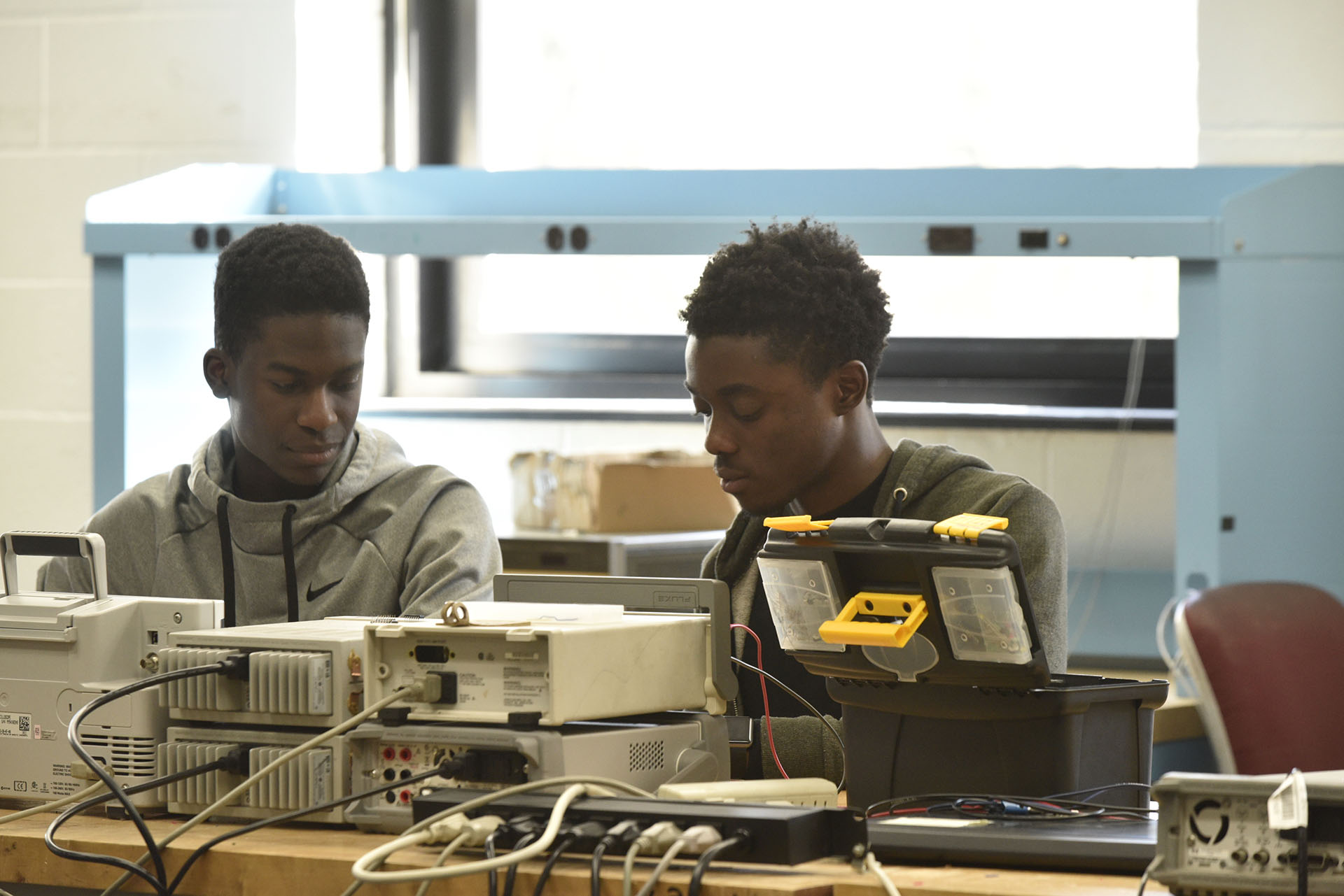 two students at a tech research desk