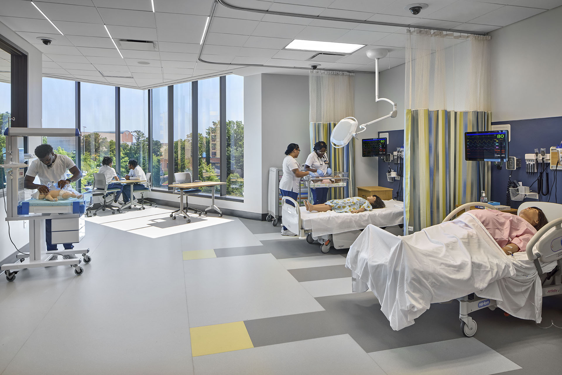 students and staff working in hospital room staging area