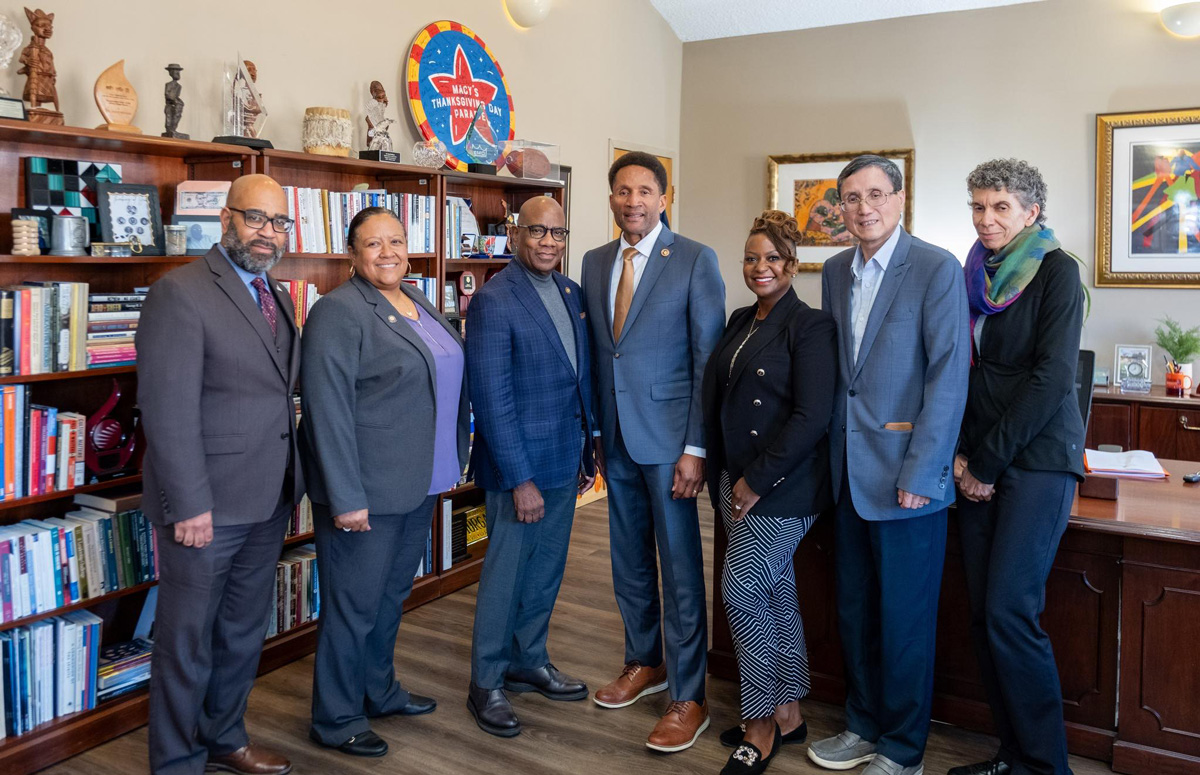 Morgan President David K. Wilson and Senator Arthur Ellis pose with members of the senior leadership team