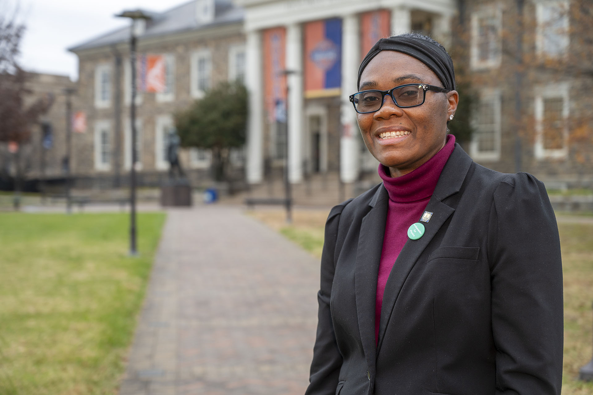 Stacyann Nelson smiling against a backdrop of Holmes Hall