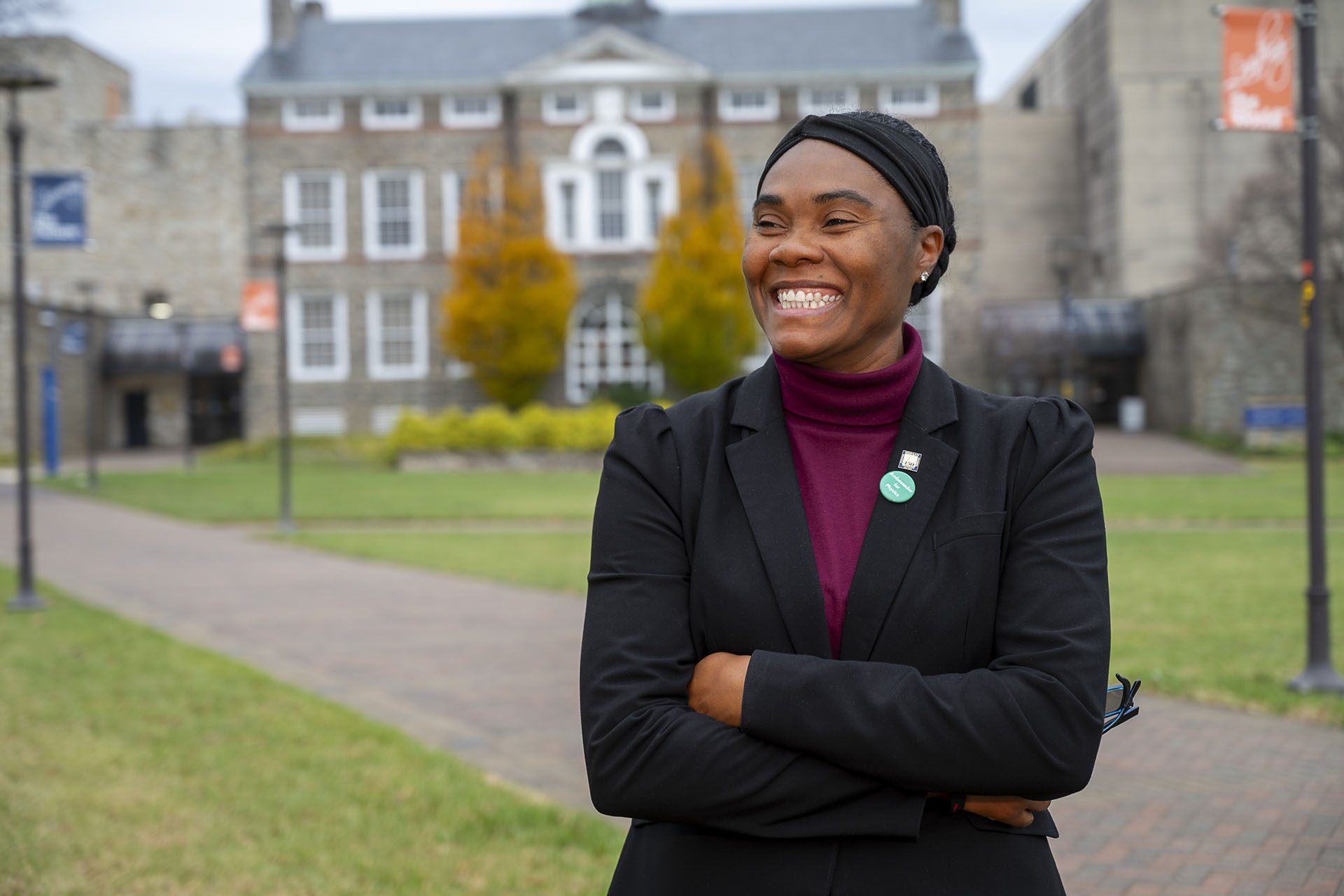 Stacyann Nelson smiling against a backdrop of Morgan's Carnegie Hall