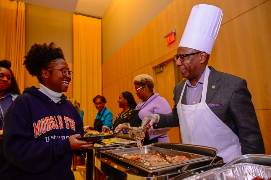 President Wilson serving thanksgiving food to student