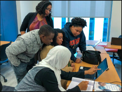 students around laptop