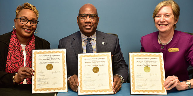 photo of presidents holding memorandum of agreement