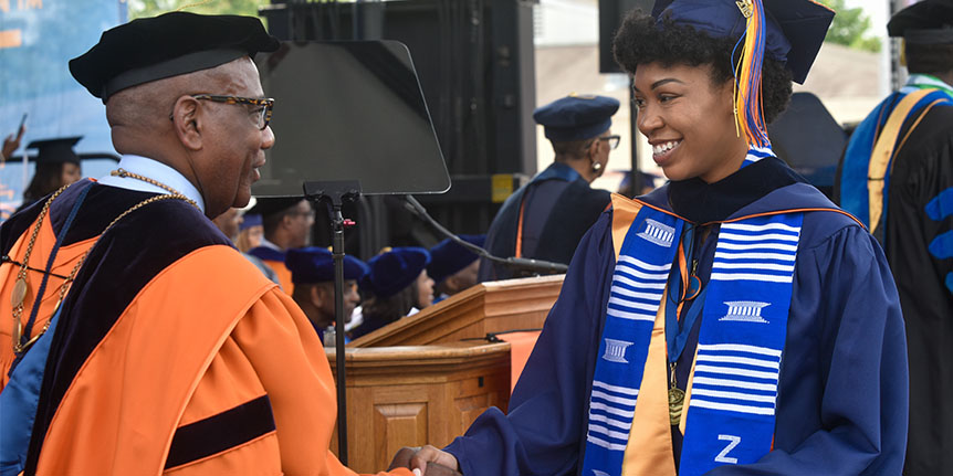 President Wilson shaking hands with female student graduate