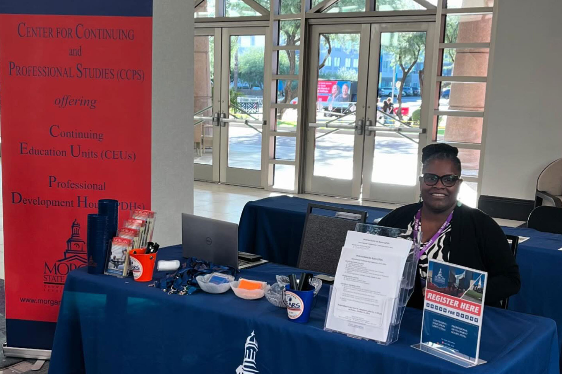 The Center for Continuing and Professional Studies Executive Director Dr. Nilajah Nyasuma Sims, works the table at a networking event.