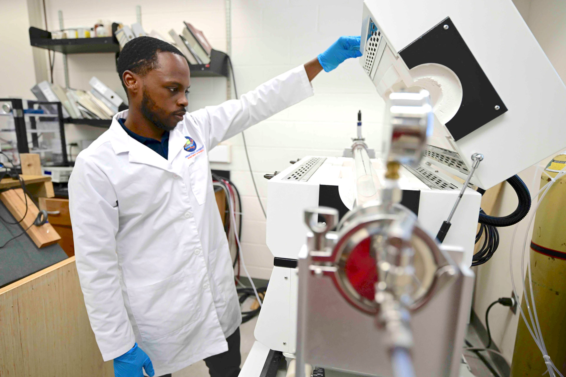 Morgan State student observing equipment in the Physics Lab.