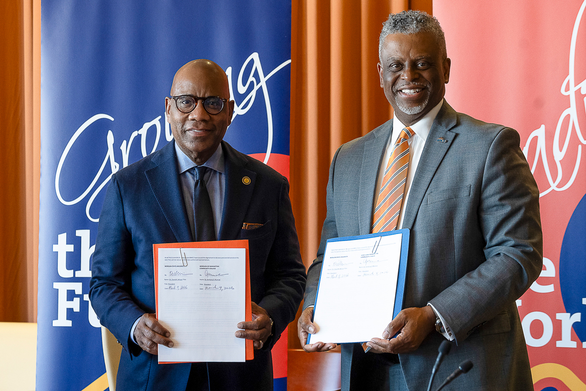 President David K. Wilson (Morgan State University) and President Anthony E. Munroe (BMCC) display the signed agreement between the two institutions.