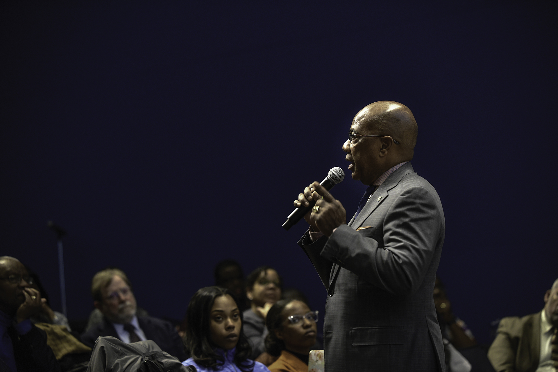 President Wilson on the microphone in a town hall