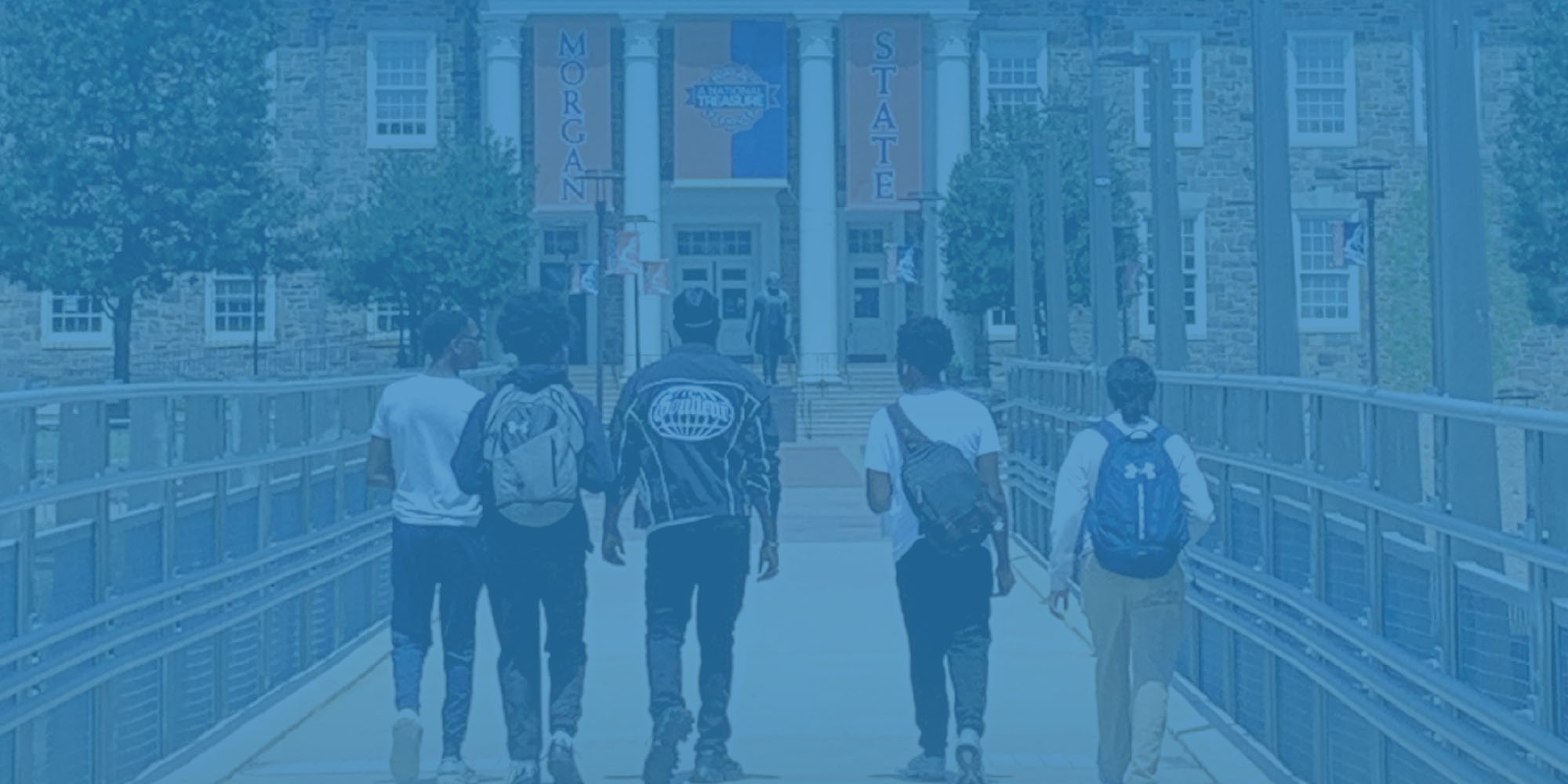 students walking on the bridge towards Holmes Hall