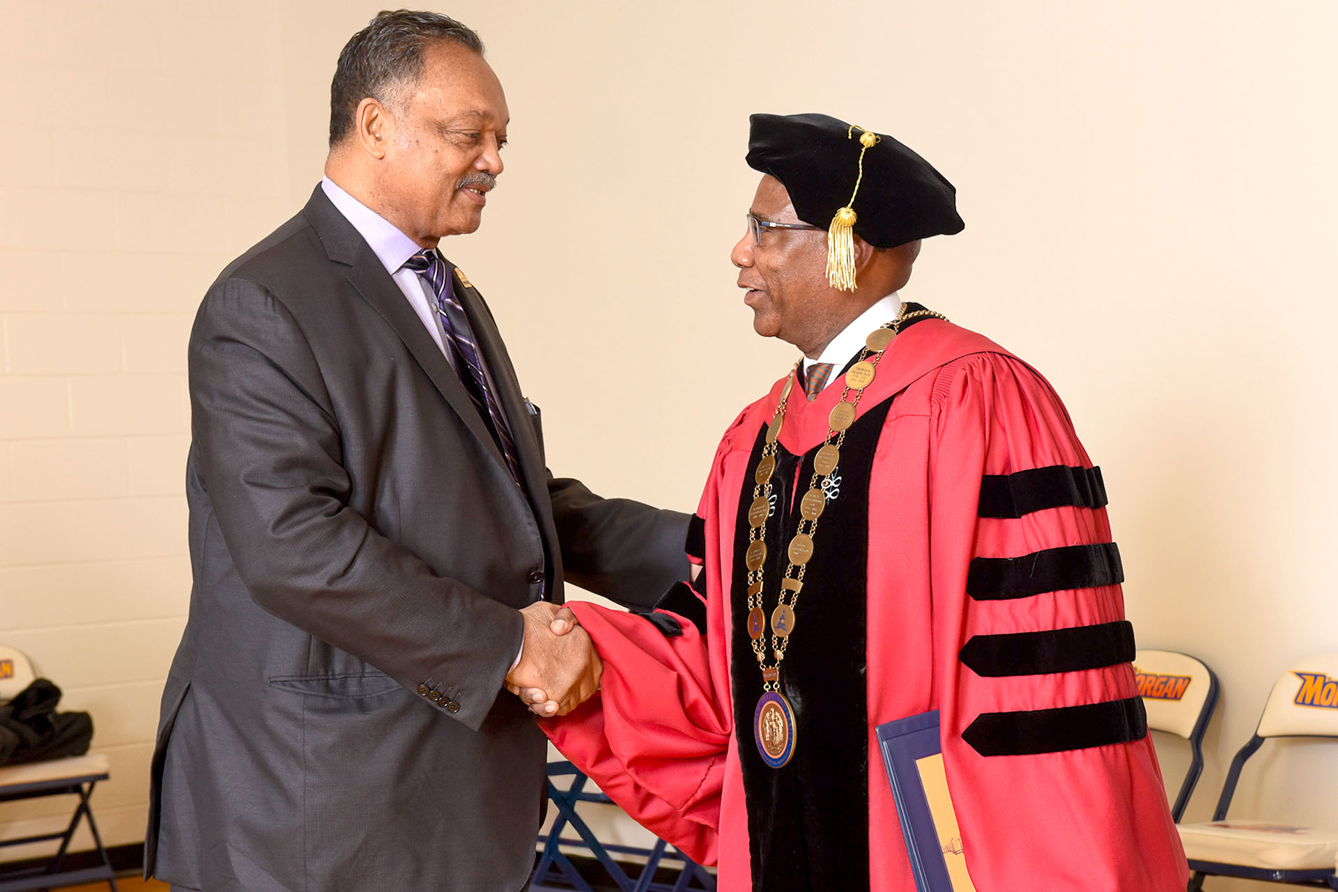 Morgan President David K. Wilson greets Rev. Jesse Jackson during 2015 Fall Commencement.